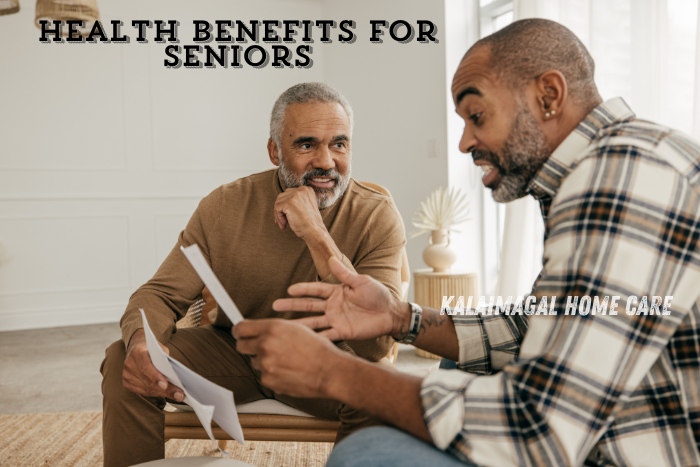 A senior discussing health benefits with a caregiver, highlighting the personalized support services offered by Kalaimagal Home Care in Coimbatore